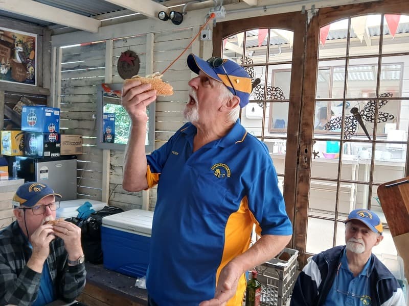 Shed members sharing food together indoors
