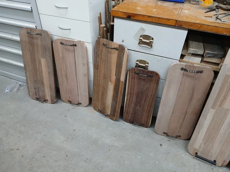 Row of charcuterie boards with metal handles